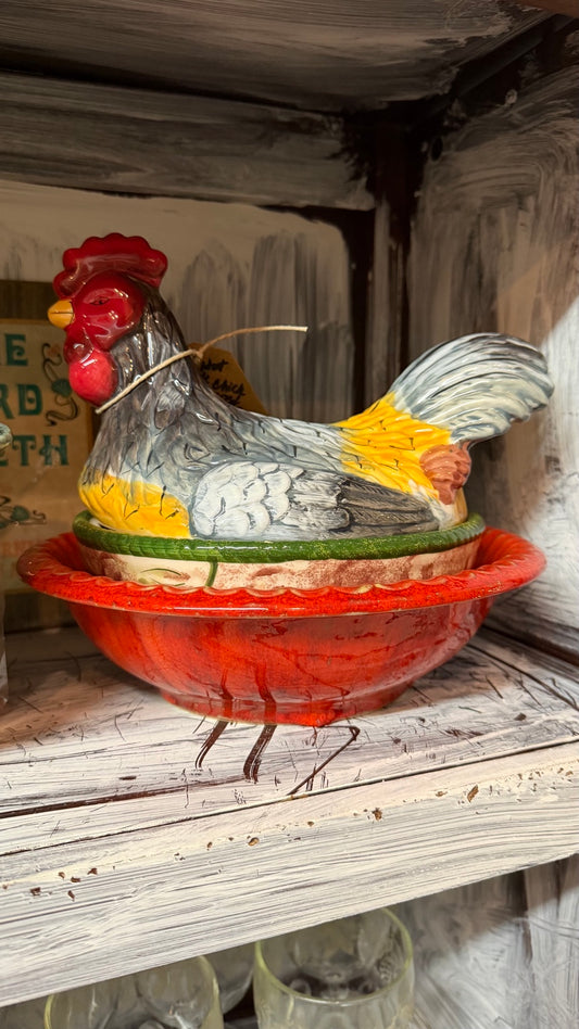 Colorful ceramic rooster on nest covered dish